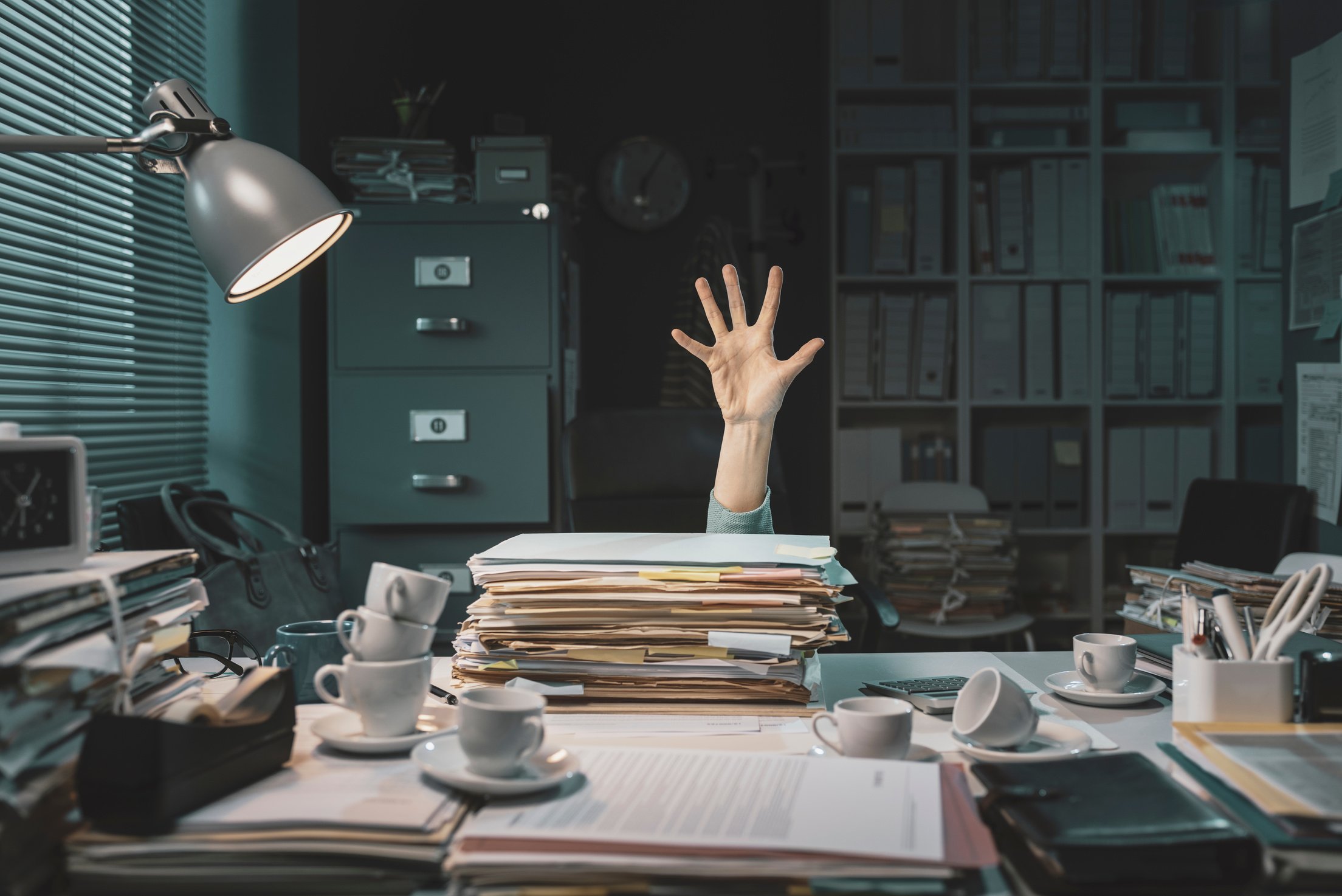 Office worker overwhelmed with paperwork